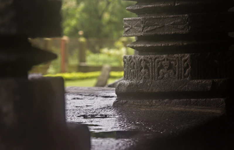 there are some stone pillars with a view of the rain