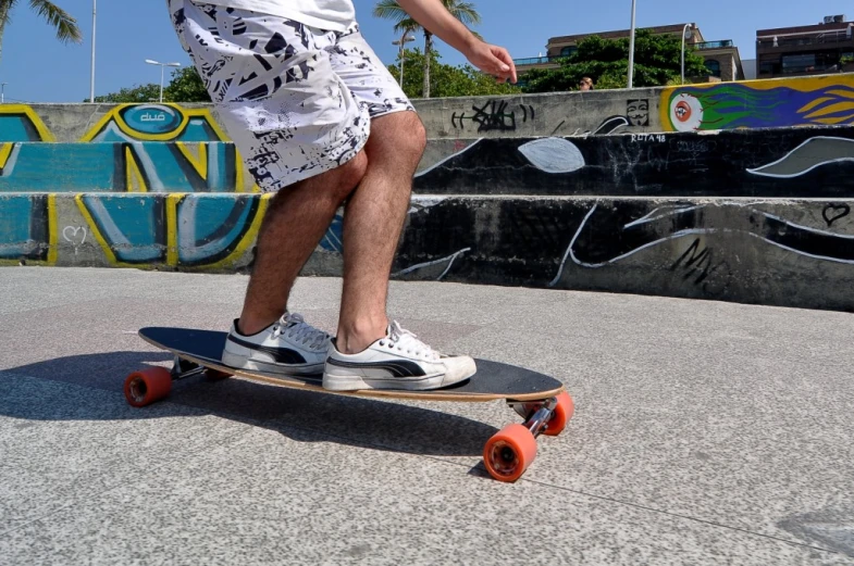 a man on a skateboard with graffiti on the background
