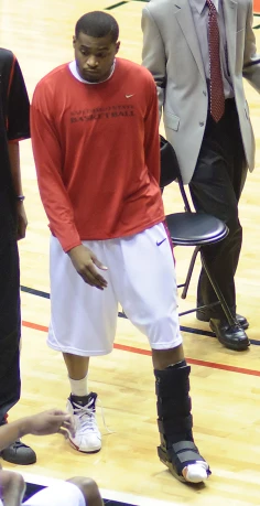 a basketball player standing on the court with a ball