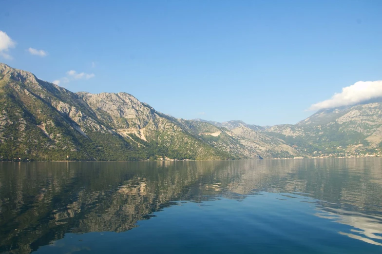 a body of water with mountains in the distance