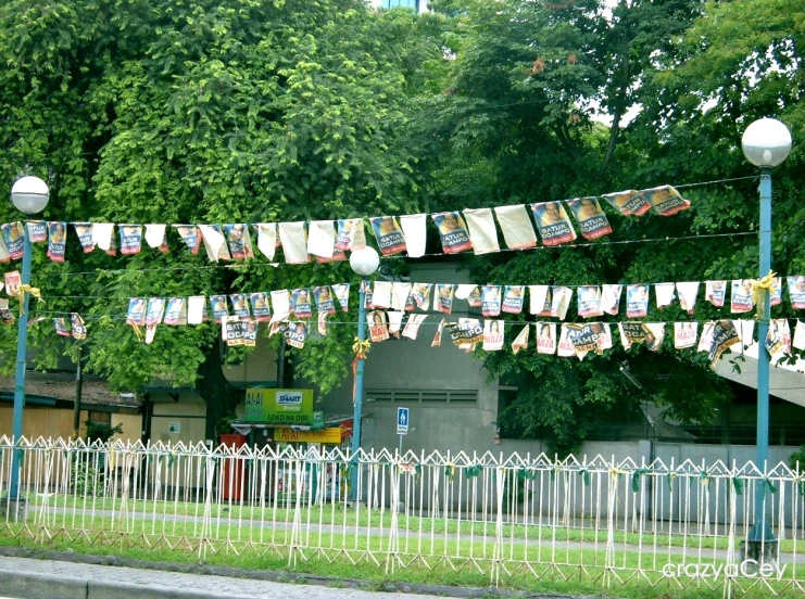 several different pictures hung above fence in residential area