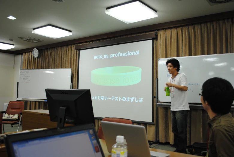 a man giving a seminar with a white board