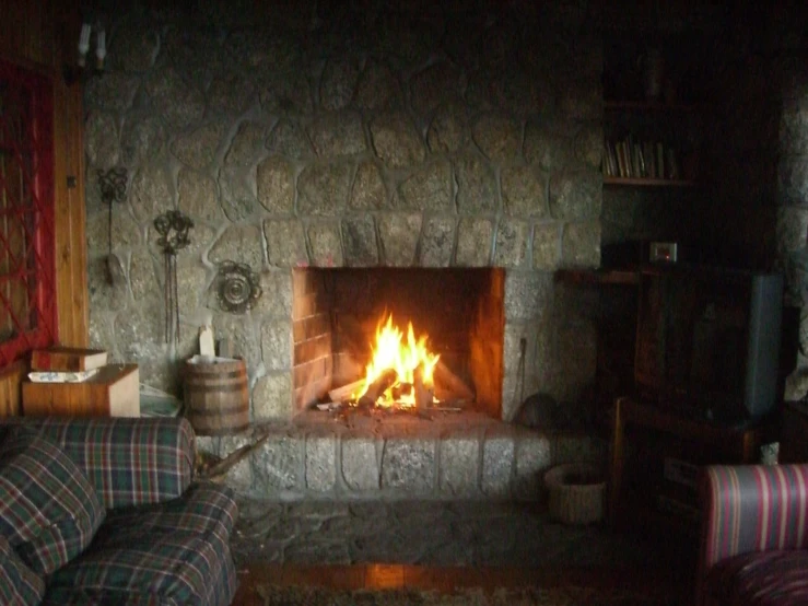 a fireplace is lit with lights in a small room