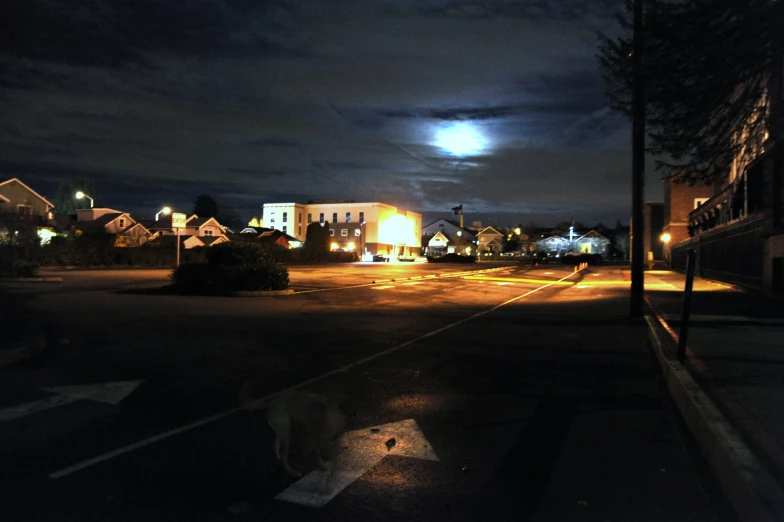 the dark street is full of cars and parked vehicles