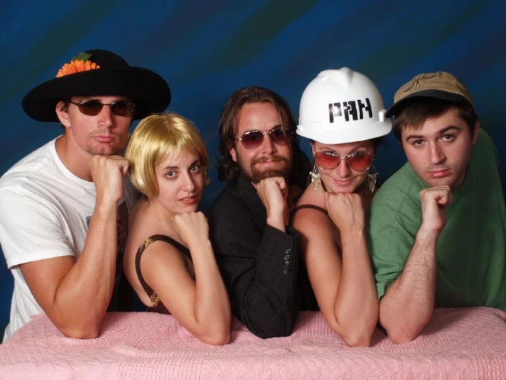 six young men are posing with their hats on