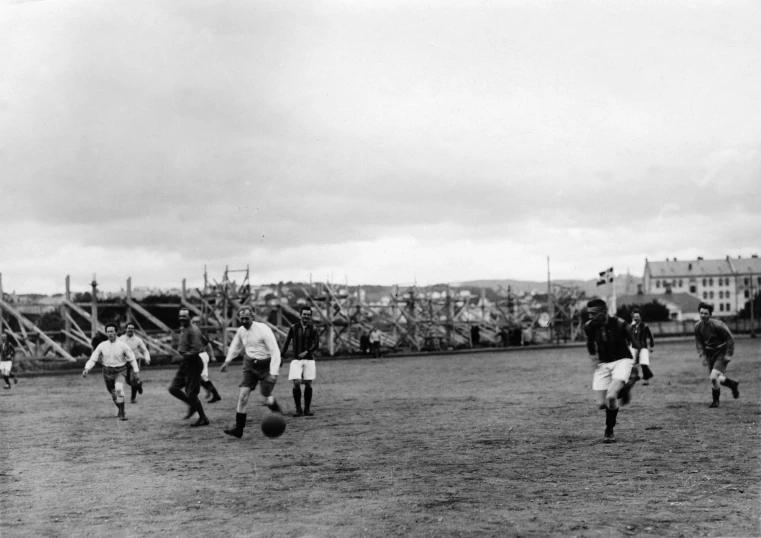 a group of people standing on top of a grass covered field