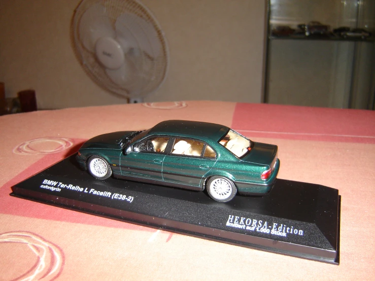 a plastic model of a green car on a table