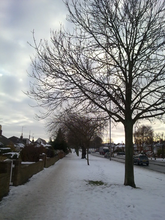 a snowy pathway with benches and people