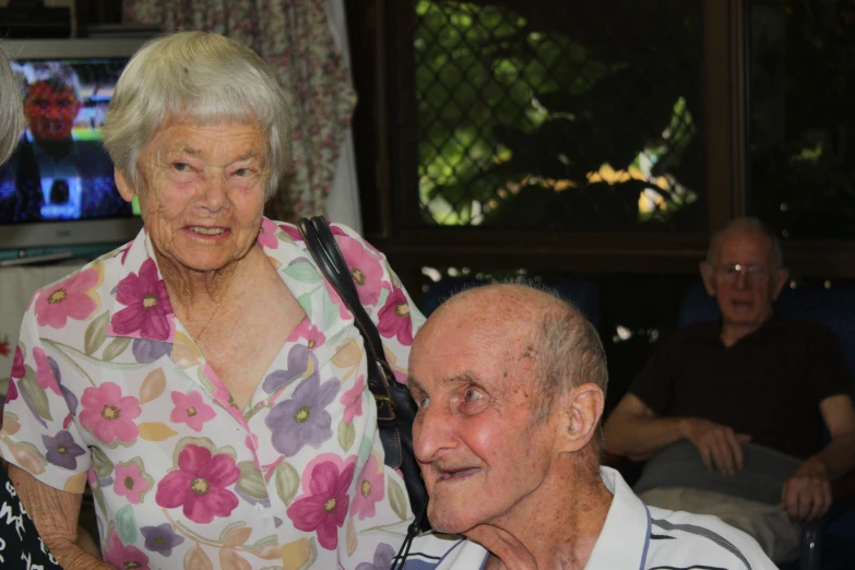 the elderly man is next to an older woman