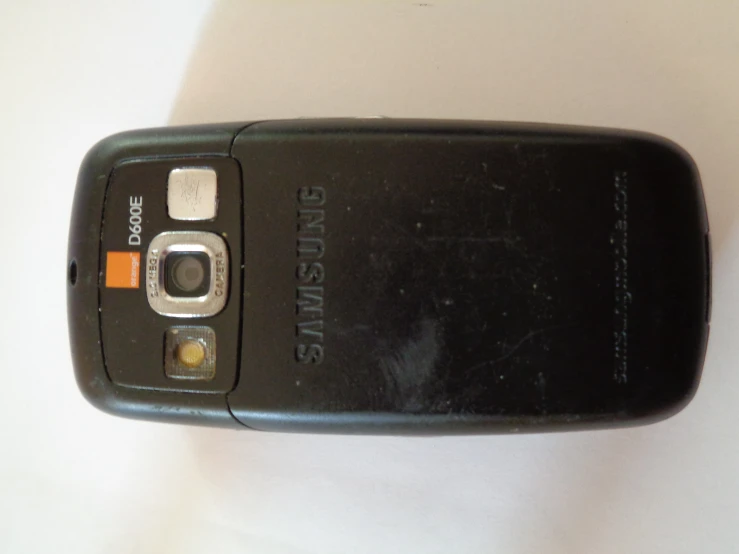 a cell phone with an orange sticker on it