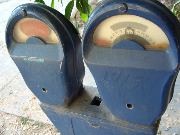 two meter meters sitting on top of a sidewalk