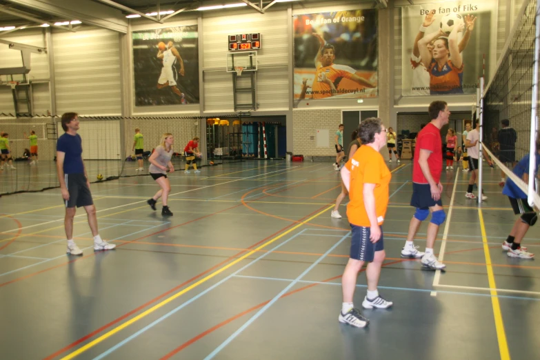 group of people on indoor sports court playing volleyball