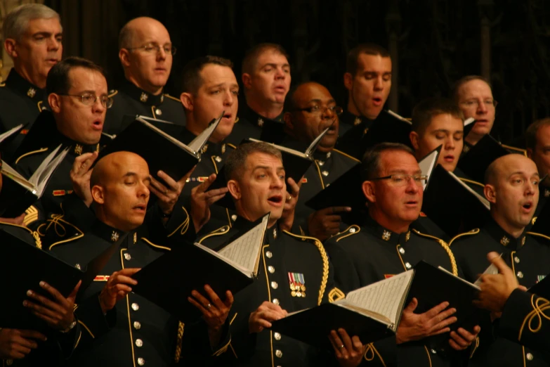 a large group of men dressed in uniforms singing