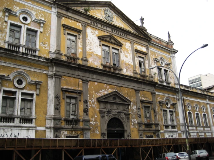 a very old building with some cars parked in front