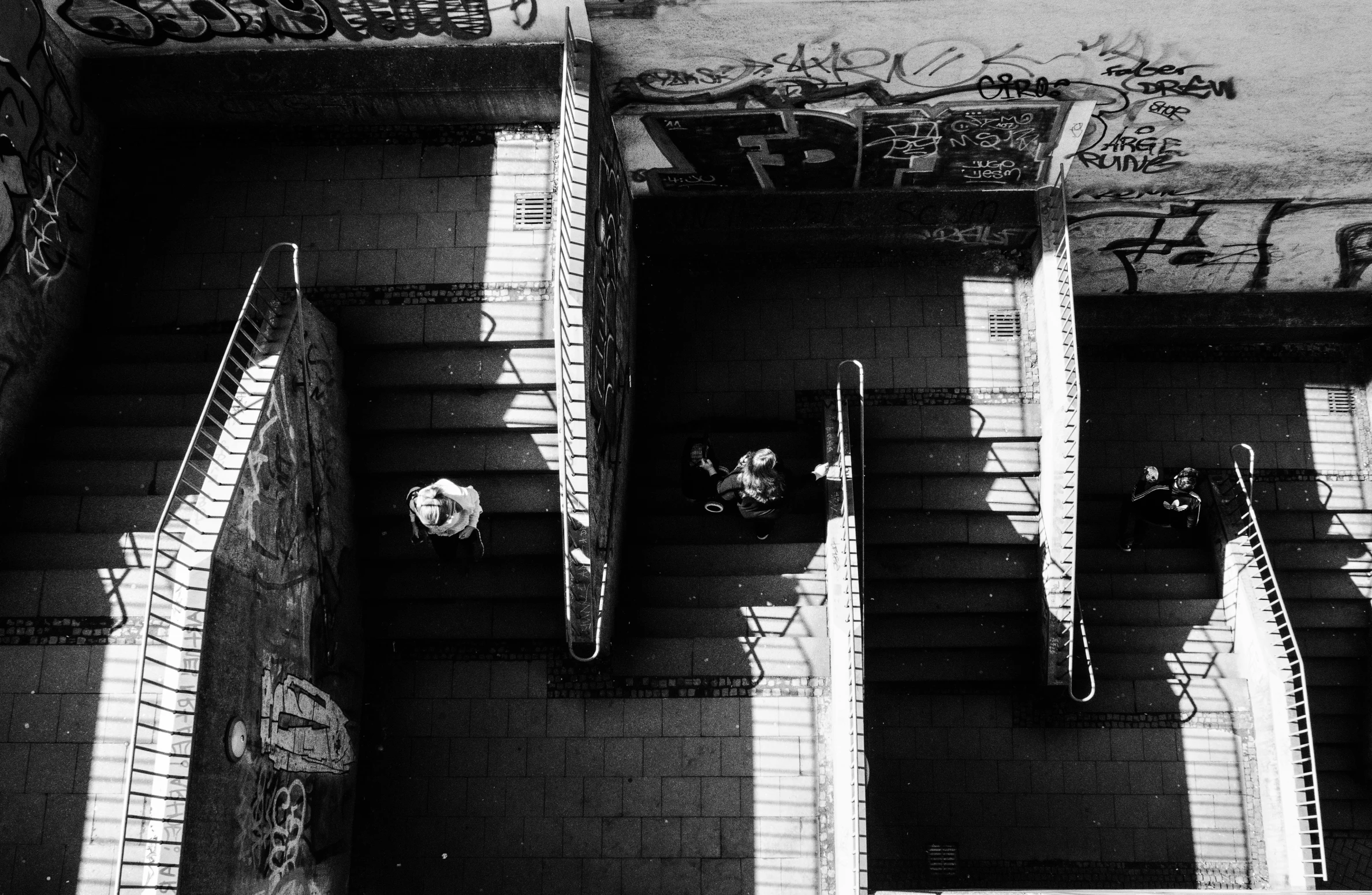 black and white pograph of steps with art and graffiti on the walls