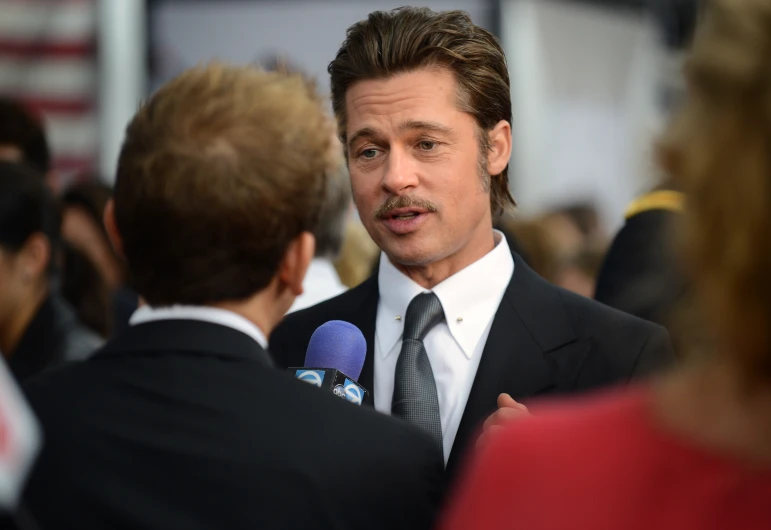 the actor speaks to the reporter during an event