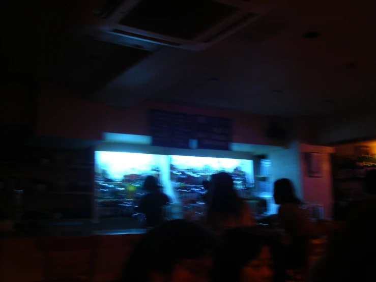 people walking in an asian restaurant at night