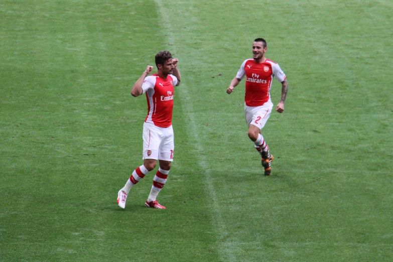 two soccer players are walking together during the game