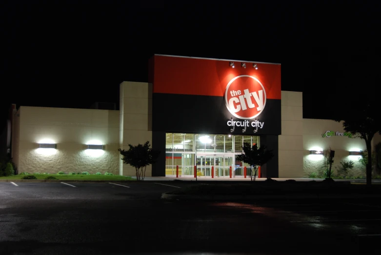 a building with a sign lit up at night