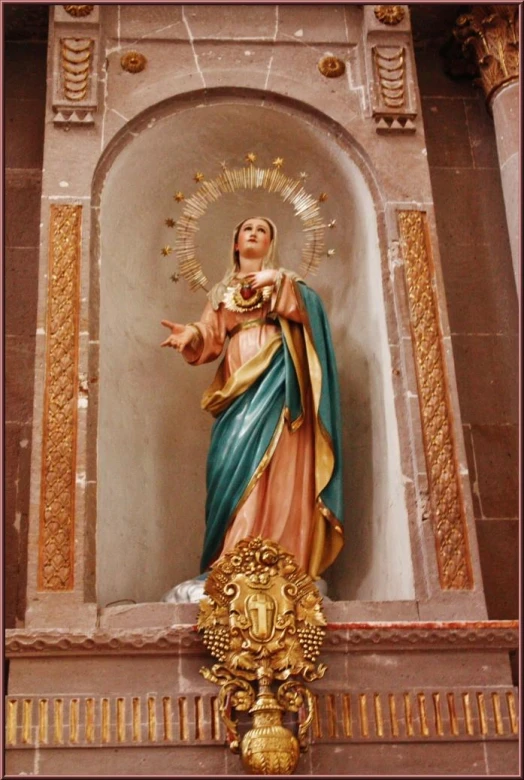 the statue of the virgin mary is located above a wall