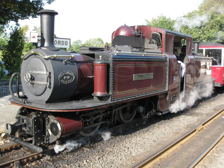 an old steam locomotive moves down the railroad tracks