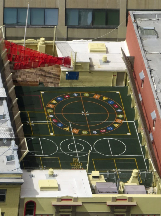 an aerial view of an apartment building with a painted court