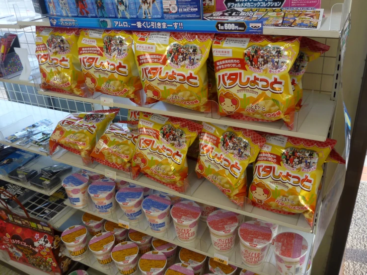 a shelf full of japanese snacks with japanese characters