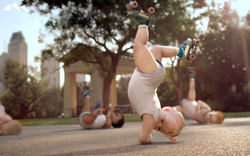 a little  with a pair of feet on his head in the air