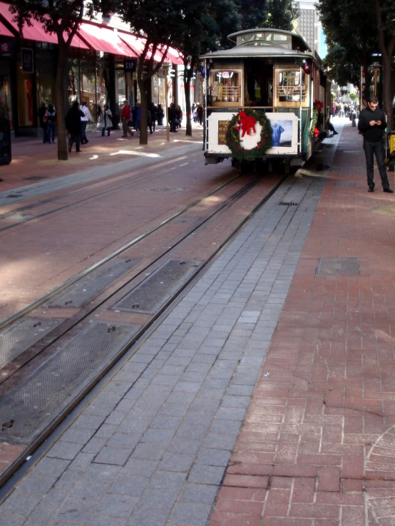 the trolley rides along the empty road in the city
