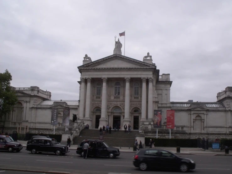 an old building with some statues on top