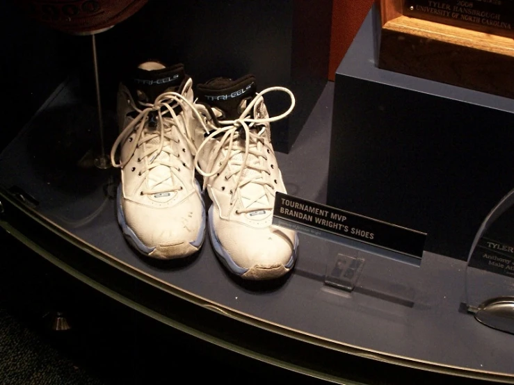 white sneakers sitting on display on a blue counter