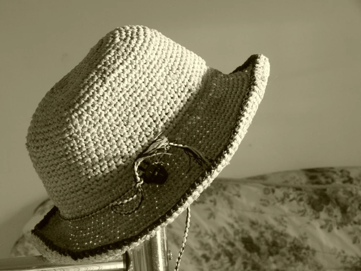 a large hat is sitting on top of a rail