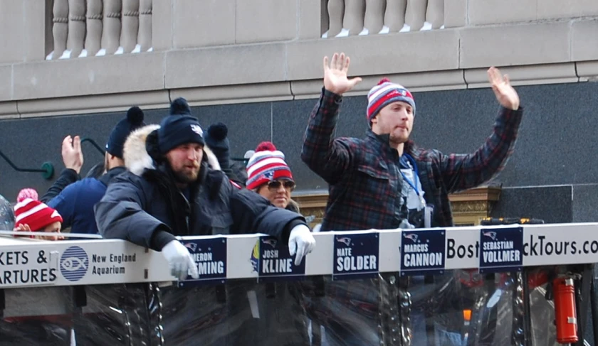 two guys in hats, two men with beards, are waving their hands