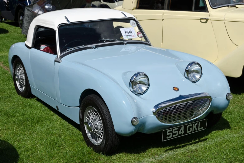 this car is parked on the green grass