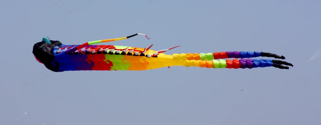 a colorful kite is flying in the sky