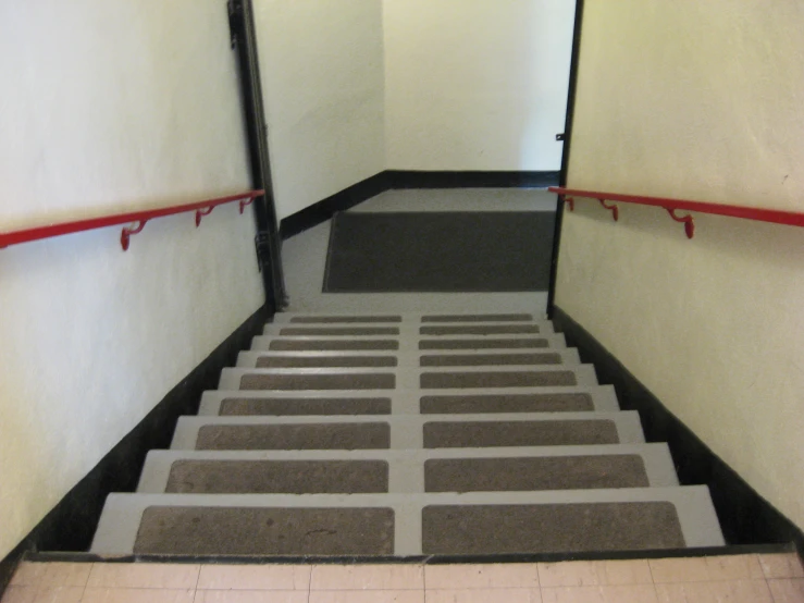 empty stairwells with tiled steps leading to two sets of elevators