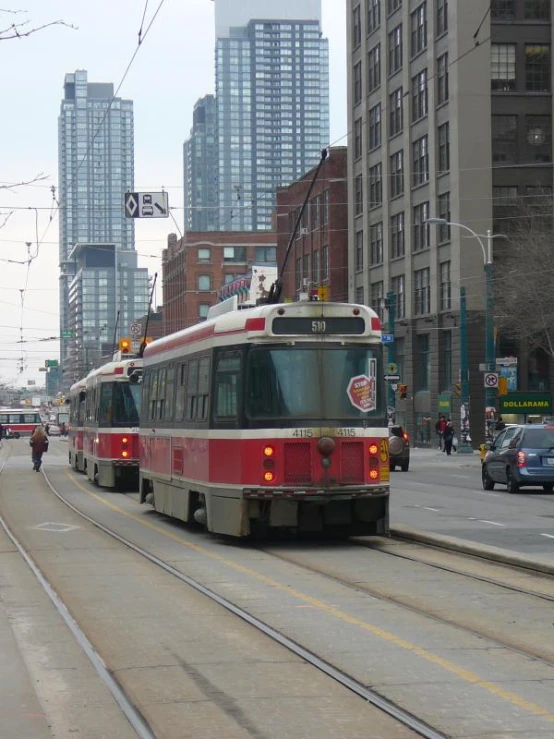 a red and white train traveling down train tracks