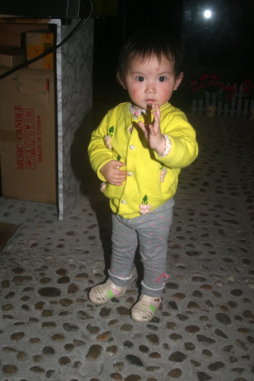 small boy is brushing his teeth on the street