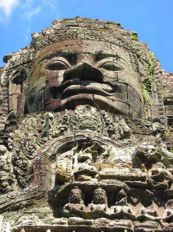 this massive stone carving of a face has a hole in the side