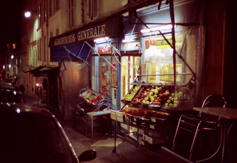 a store front is lit up with dim lighting at night