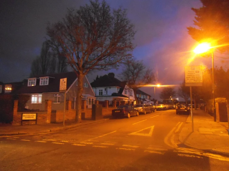 dark street with house lit up on the side