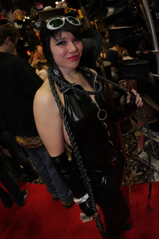 a woman dressed up in a leather outfit, with chains and glasses