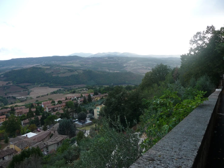 some trees and buildings overlooking some hills