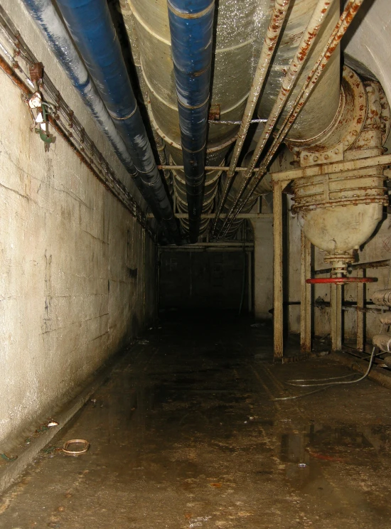 an under ground tunnel with piping and wires