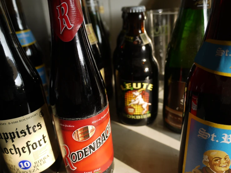 an assortment of beverages sit on a counter