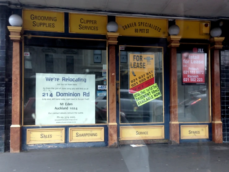 several different signs on the door to a business