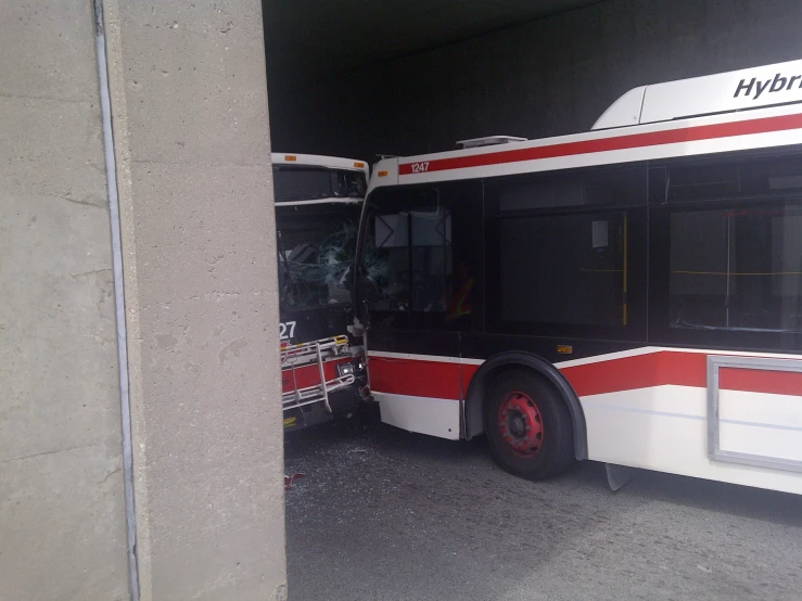 the double decker bus is parked in front of the building