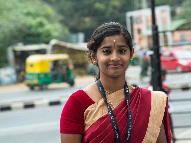 a young lady is standing in a rural city