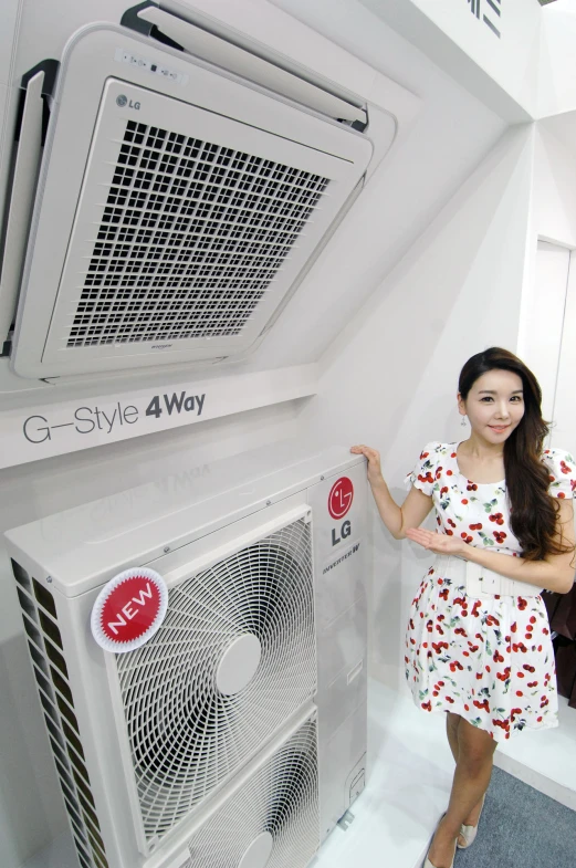 an attractive young woman in a dress is standing next to air conditioners