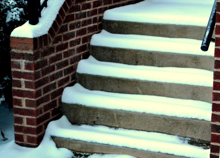 a snow covered staircase is pictured on a snowy day